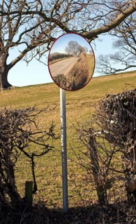 Using a convex mirror to see road traffic from the farm entrance