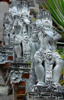 Several historical statues of Hindu deities Hindu god Brahma with four heads at stairway to Hindu temple