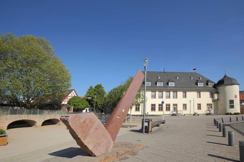 Winery building with witch tower built in 1719 and modern sculpture at the Kellereiplatz in Hofheim