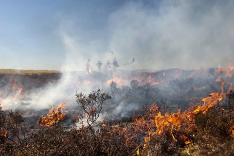 Firefighters tackling heather moor fire on a shooting range that had got out of control