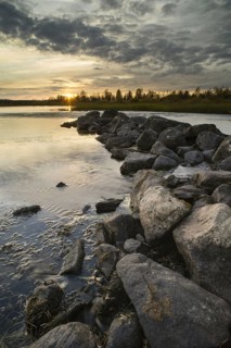 View of rocks and lake at sunset