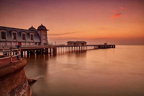 View of Victorian pier in seaside town at sunrise