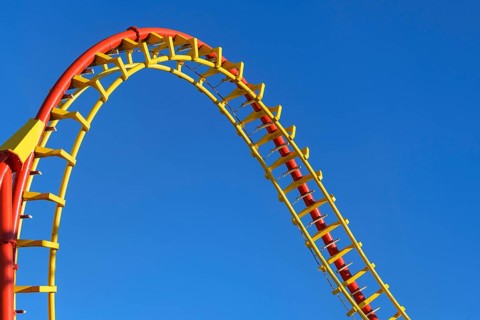 Roller coaster in front of blue sky