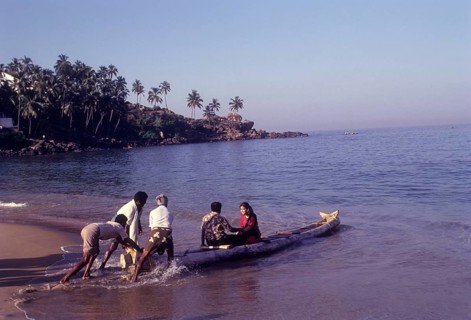 A couple enjoying a catamaran or kattumaram ride at Kovalam beach near Thiruvananthapuram
