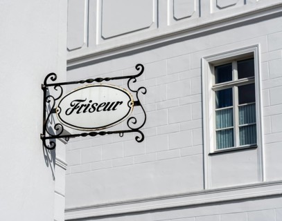 Old ceramic sign on a barbershop