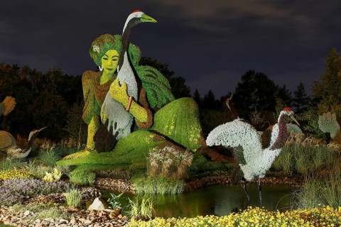 Light painting photography of a garden sculpture