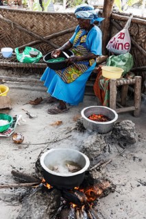 Woman cooking over an open fire