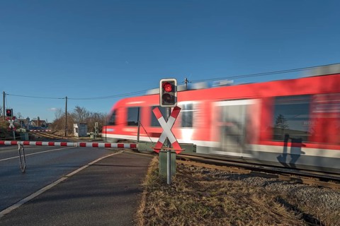 Passing train at a level crossing with barriers