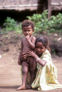 Belta kurumba tribal girl sitting with her brother in Mudumalai