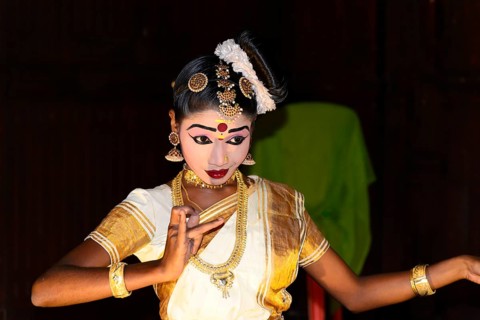 Fully made up and costumed Kathakali dancer performing