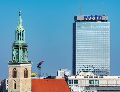 Church tower of St. Mary's Church with the Park Inn Hotel am Alexanderplatz