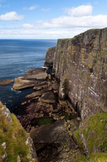 View of Torridonian red sandstone sea cliffs in northwest of island