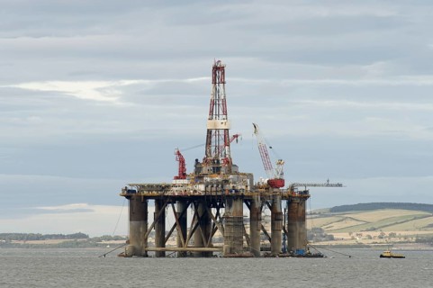 Oil rig moored in sea near coast