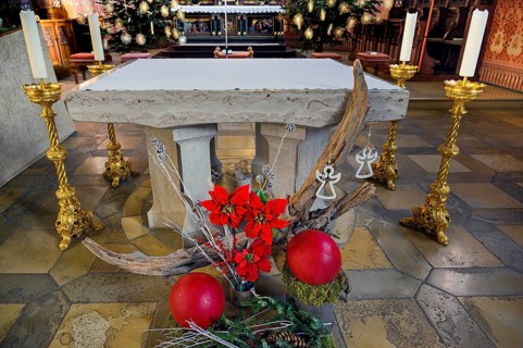 Main altar with floral decorations and candles