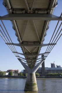 Under the steel suspension bridge over the river