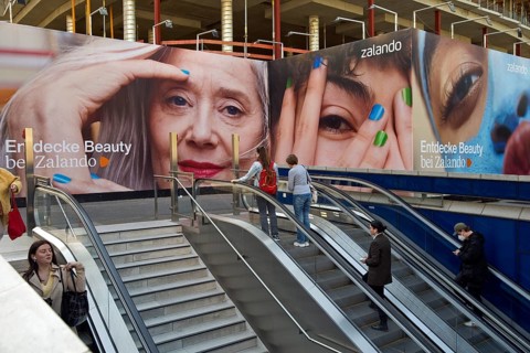 Large advertising posters on the stairs to the underground to hide the construction site behind