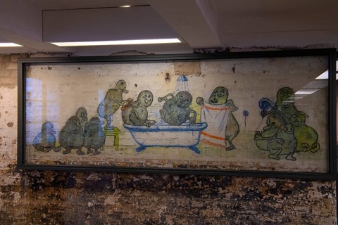 Mural of prisoners in the former potato peeling cellar of the camp kitchen