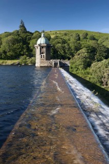 Dam spillway and pump house at reservoir