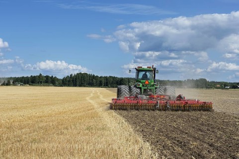 John Deere 9400 pulling Vaderstad TopDown 700 cultivator and tilling stubble field