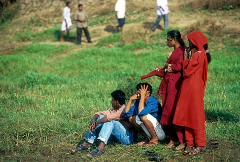 Spectators standing near the shore of Pamba River