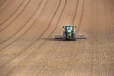 John Deere tractor pulling the soil press