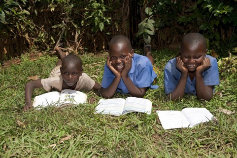 Smiling Rwandan children reading school books. Rwanda