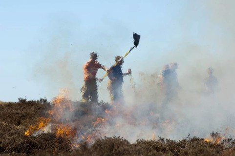 Firefighters tackling heather moor fire on a shooting range that had got out of control