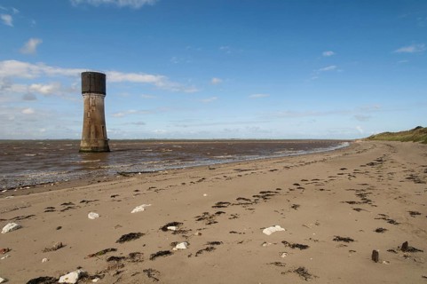 View of beach and former lighthouse converted to water-tower