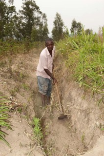 Farmers dig a ditch on the hillside to catch rainfall and prevent rapid soil erosion
