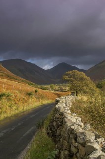 View of drystone wall at roadside in upland valley