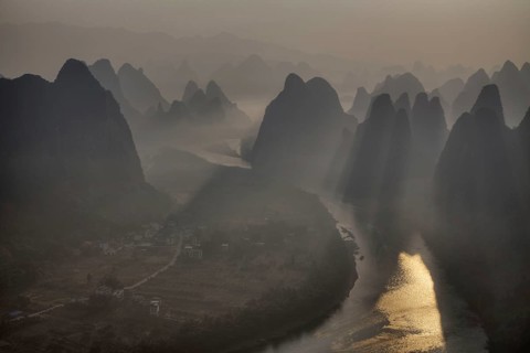 View of limestone karst formations along the river at sunrise