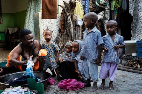 Woman with laundry in plastic bowl