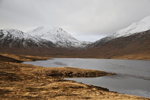 View across freshwater loch towards fishing hut