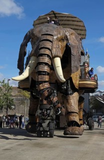 Tourists riding on gigantic mechanical elephant