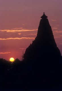 The Kandariya Mahadeva temple against glowing sun set in the Khajuraho