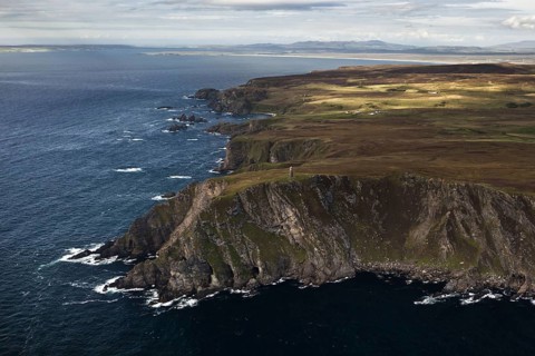 Aerial view of coastline with cliffs and commemorative monument