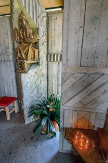 Figure of the saint with floral decoration and sacrificial candles