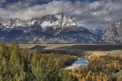 View of mountain range and forested river valley