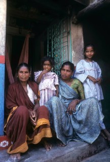 Fisher women sitting infront of the house