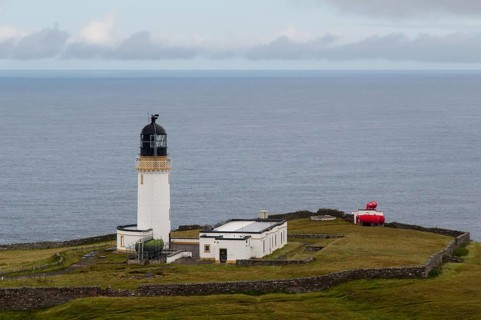 View of lighthouse and foghorn on coastal clifftop