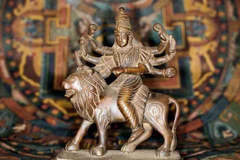 Bronze figure of the Indian goddess Durga riding on a lion figurine