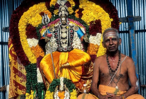 Decorated god with priest