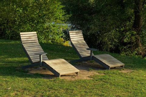 Wooden loungers on the river bank