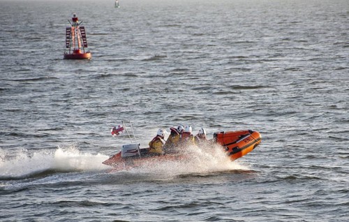 RNLI D-class inflatable lifeboat in harbour entrance