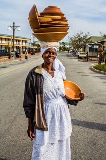 Woman with wooden bowls on her head