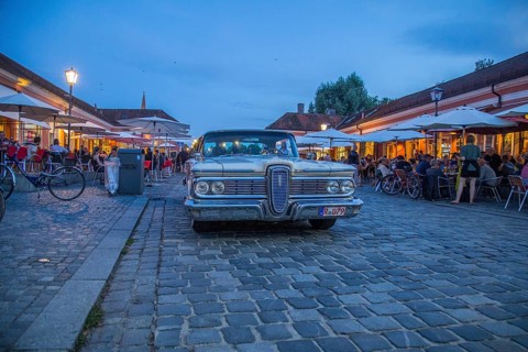 Evening scene in the Stadtamhof nightlife district with US street cruiser as eye-catcher