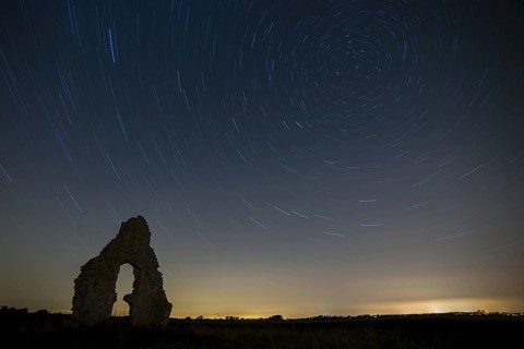 Church ruins and star trails at night