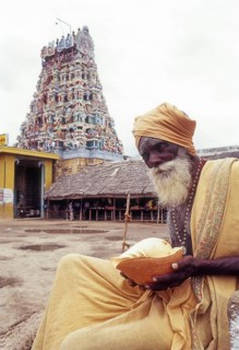 Sadhu holding conch standing infornt of Nataraja temple in Perur near Coimbatore