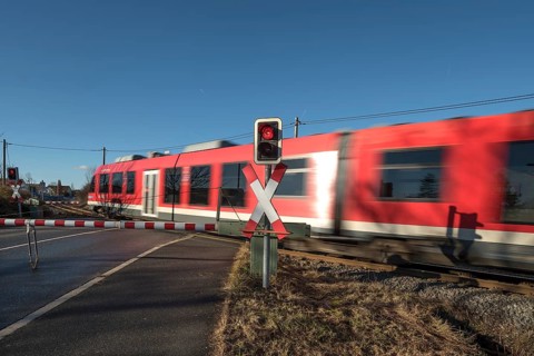 Passing train at a level crossing with barriers