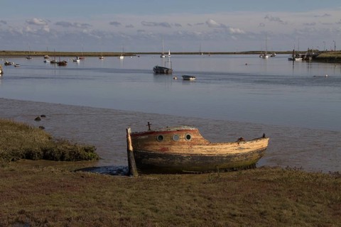Abandoned boat on the tidal flats of the River Ore near Orford